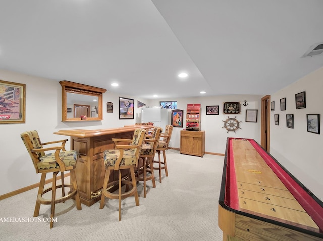 bar with a dry bar, recessed lighting, light colored carpet, visible vents, and baseboards