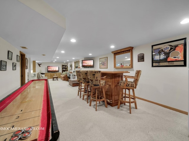 interior space featuring recessed lighting, carpet flooring, visible vents, baseboards, and a dry bar