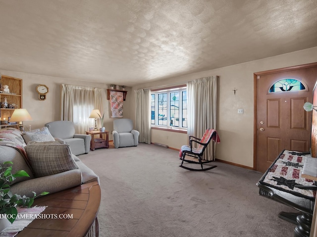 carpeted living room with a textured ceiling and baseboards