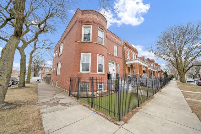 exterior space with a fenced front yard, a residential view, and brick siding