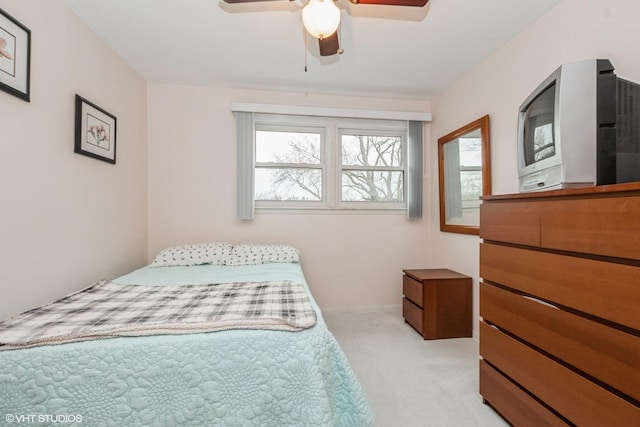 bedroom with light carpet and ceiling fan