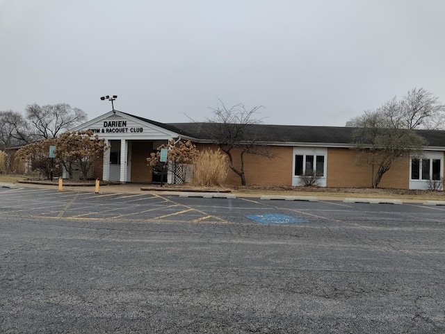 view of building exterior with uncovered parking