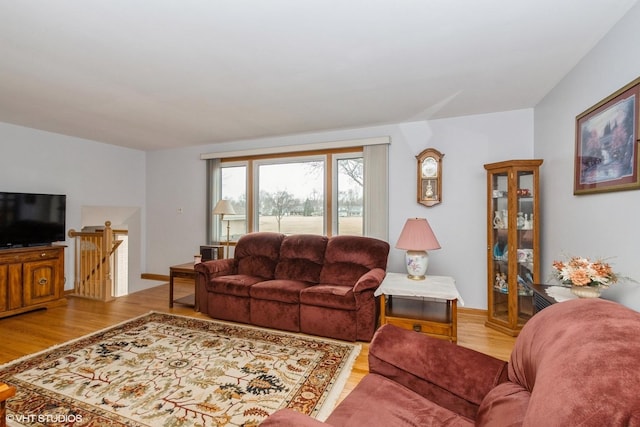 living area featuring light wood-type flooring and baseboards