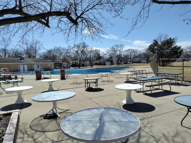 community pool featuring a patio area and fence