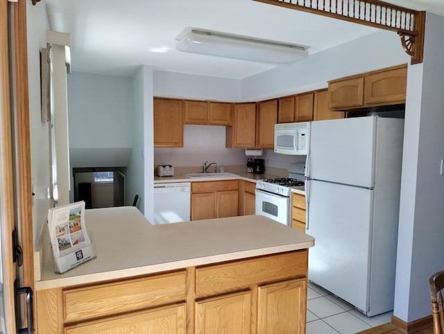 kitchen featuring light tile patterned flooring, a peninsula, white appliances, a sink, and light countertops