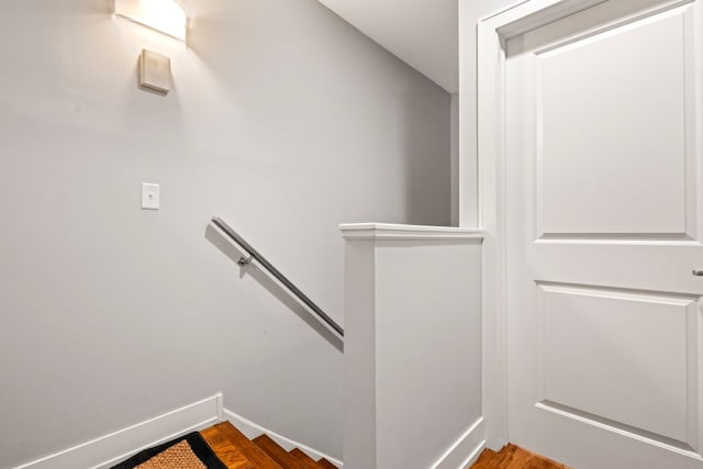 stairway with baseboards and wood finished floors