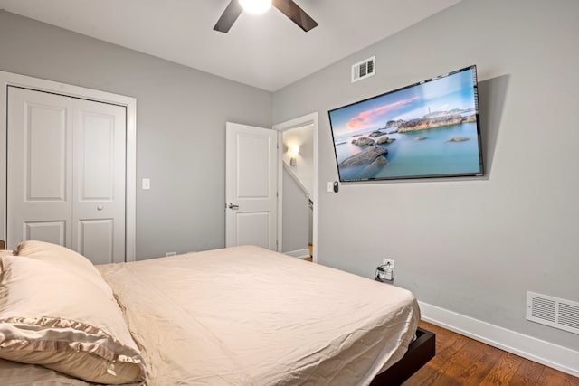 bedroom featuring ceiling fan, wood finished floors, visible vents, and baseboards