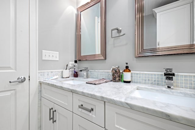 full bathroom with a sink and double vanity