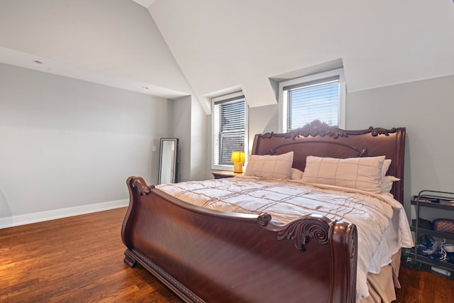 bedroom featuring high vaulted ceiling, baseboards, and wood finished floors