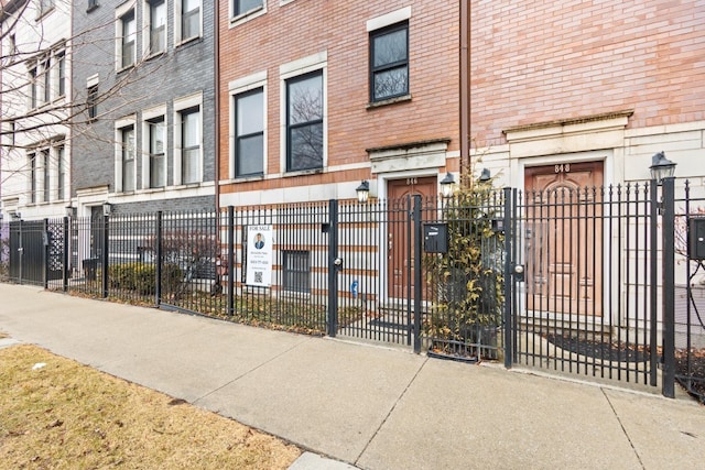 exterior space with a fenced front yard and a residential view