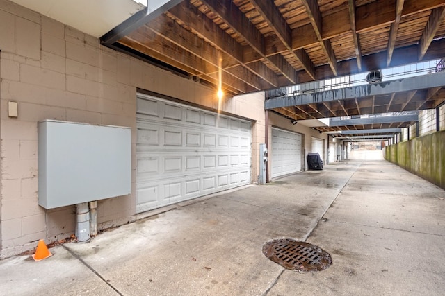 garage with concrete block wall