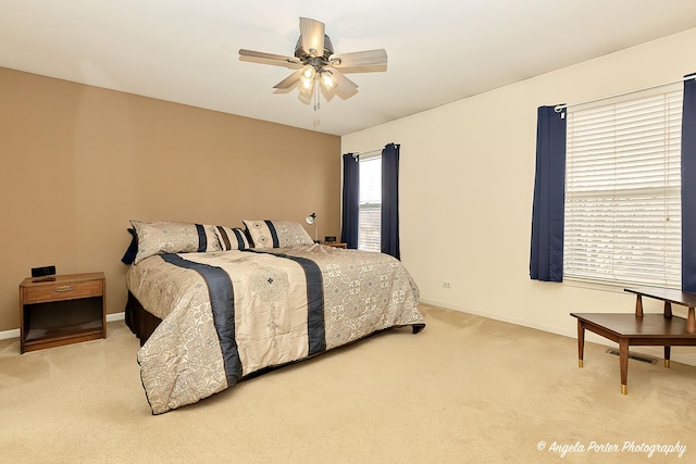 carpeted bedroom featuring visible vents, ceiling fan, and baseboards