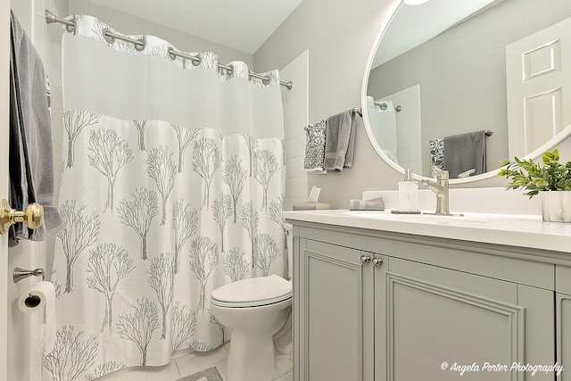 full bathroom featuring curtained shower, vanity, and toilet