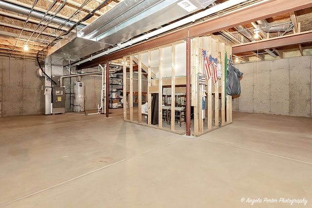 unfinished basement with heating unit and gas water heater