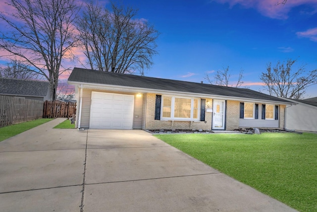 ranch-style house featuring driveway, fence, a front yard, a garage, and brick siding