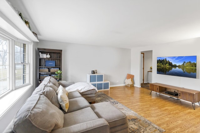 living area featuring wood finished floors and baseboards