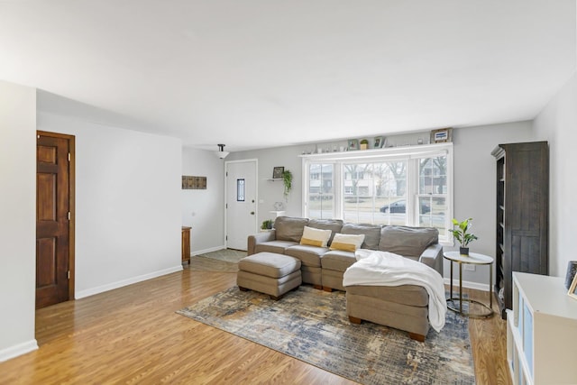 living room featuring baseboards and wood finished floors