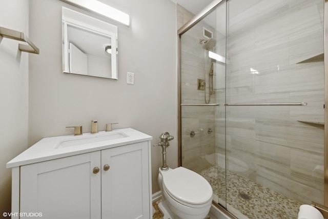 full bathroom with toilet, a shower stall, and vanity