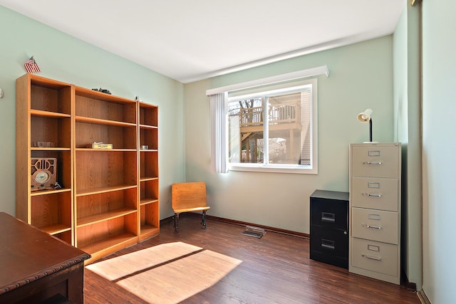 sitting room featuring baseboards and dark wood-style flooring