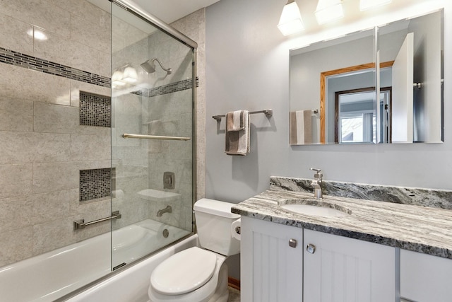 full bath featuring vanity, toilet, and enclosed tub / shower combo