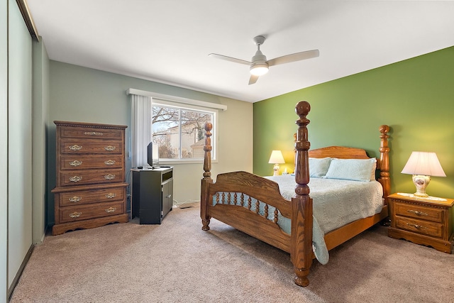 bedroom with light carpet and a ceiling fan