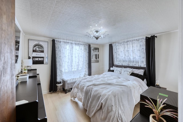 bedroom featuring crown molding and wood finished floors