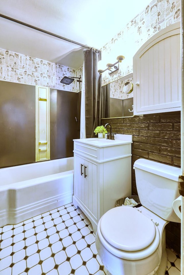 bathroom with wallpapered walls, toilet, shower / tub combo with curtain, tile patterned floors, and vanity