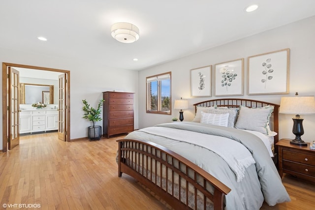 bedroom with recessed lighting, light wood-type flooring, baseboards, and ensuite bath