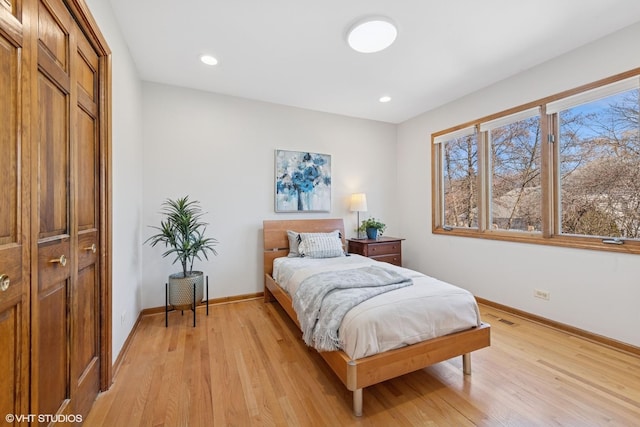 bedroom with recessed lighting, baseboards, and light wood finished floors