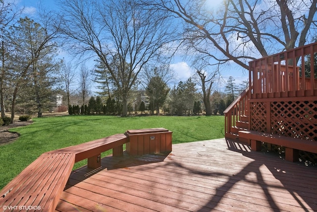 wooden deck with a yard and stairway