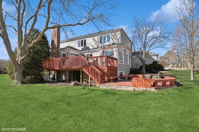 back of house with a deck, stairway, and a yard