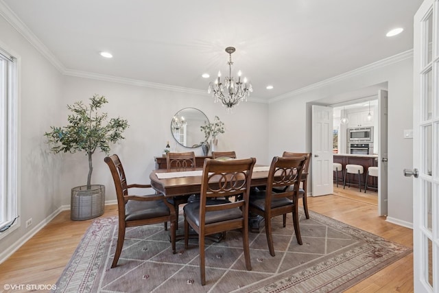 dining space featuring a chandelier, recessed lighting, crown molding, and light wood-style floors