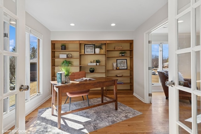 office with recessed lighting, french doors, a healthy amount of sunlight, and light wood-style flooring