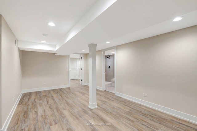 finished basement featuring recessed lighting, light wood-style flooring, and baseboards