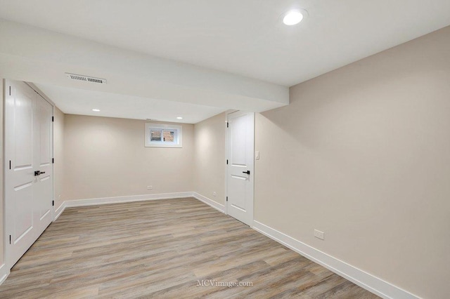 below grade area featuring light wood-style floors, visible vents, baseboards, and recessed lighting