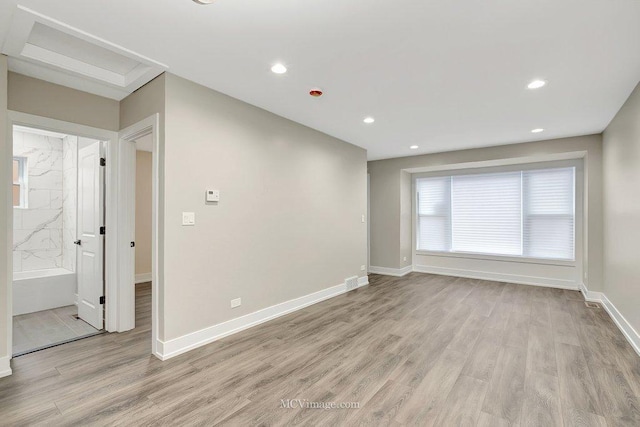 unfurnished room with recessed lighting, light wood-style flooring, and baseboards