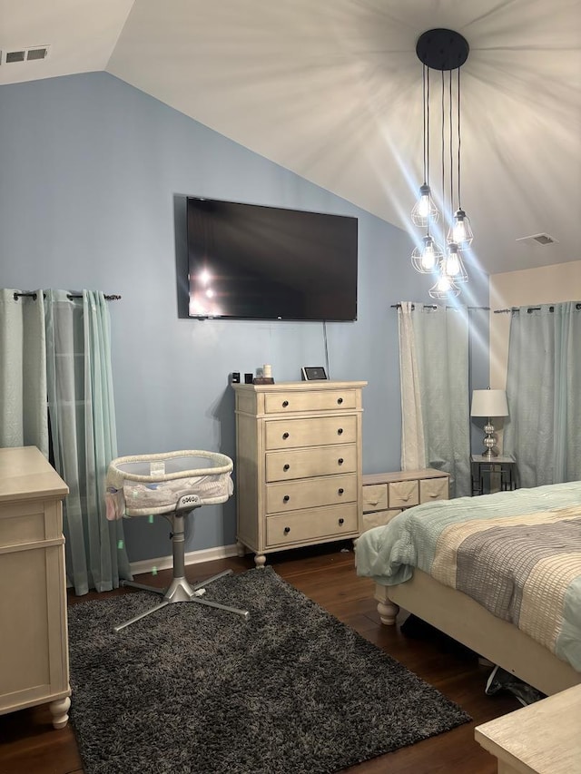 bedroom featuring visible vents, vaulted ceiling, and wood finished floors