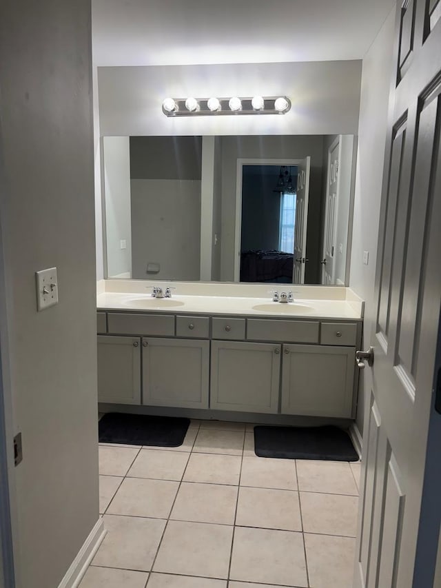 full bathroom featuring double vanity, a sink, ensuite bath, and tile patterned floors