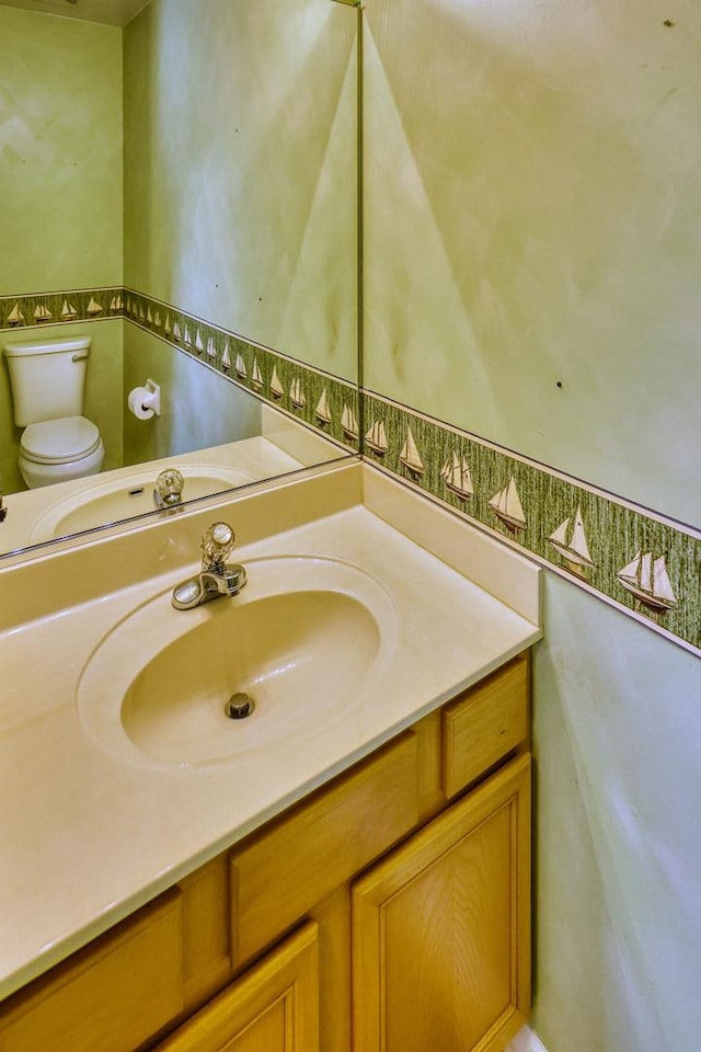 bathroom featuring toilet and vanity