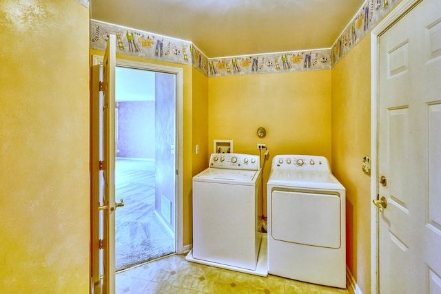 washroom featuring tile patterned floors, laundry area, and separate washer and dryer