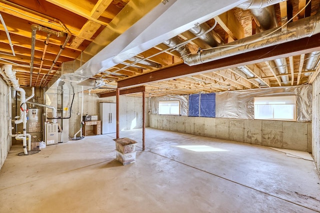 basement with gas water heater and heating unit