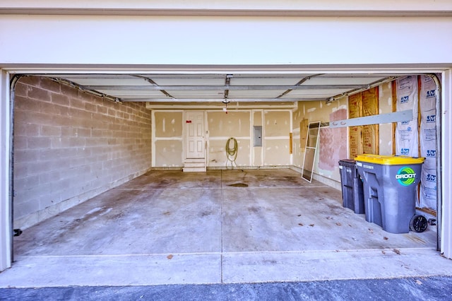 garage with electric panel and driveway