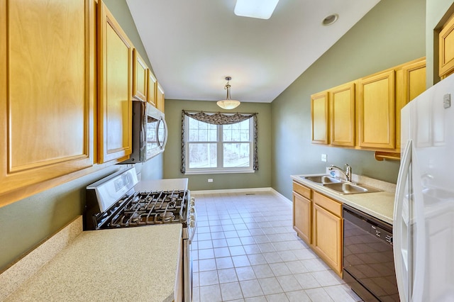 kitchen with light brown cabinets, a sink, appliances with stainless steel finishes, light tile patterned floors, and vaulted ceiling