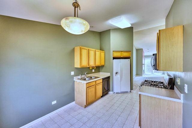 kitchen featuring a sink, stainless steel microwave, gas range oven, white fridge with ice dispenser, and dishwasher