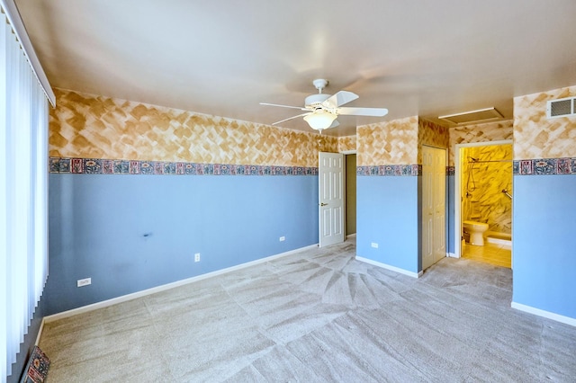 empty room with a ceiling fan, visible vents, baseboards, wallpapered walls, and light carpet