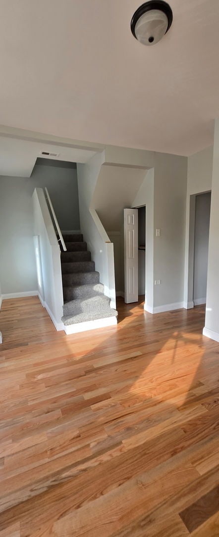 stairway featuring wood finished floors and baseboards