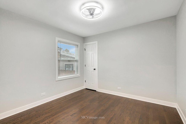 unfurnished room featuring dark wood finished floors and baseboards