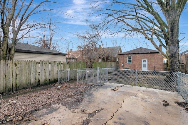 exterior space with a gate and a fenced backyard