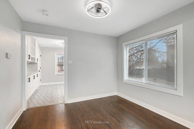 interior space with baseboards and wood finished floors