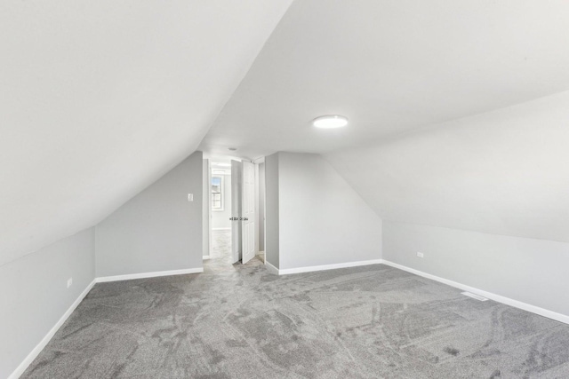 bonus room featuring carpet, lofted ceiling, and baseboards